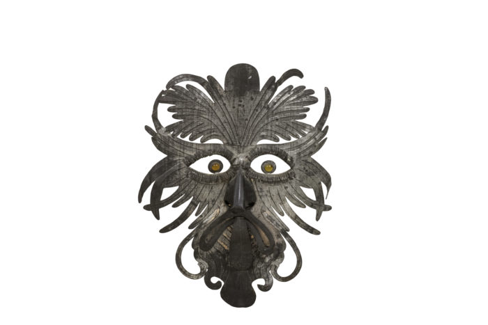 grotesque mask embossed silvered metal