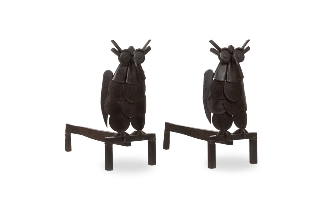 Pair of iron andirons, representing an owl. 1950s.